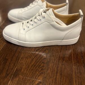 Christian Louboutin's classic white sneakers.